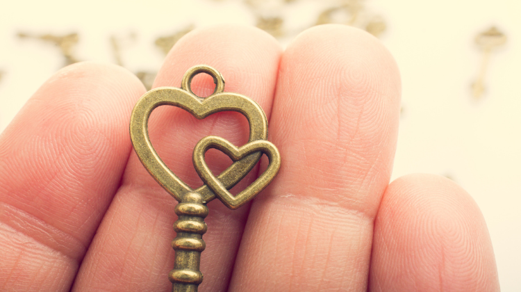A person holding a heart-shaped set of keys