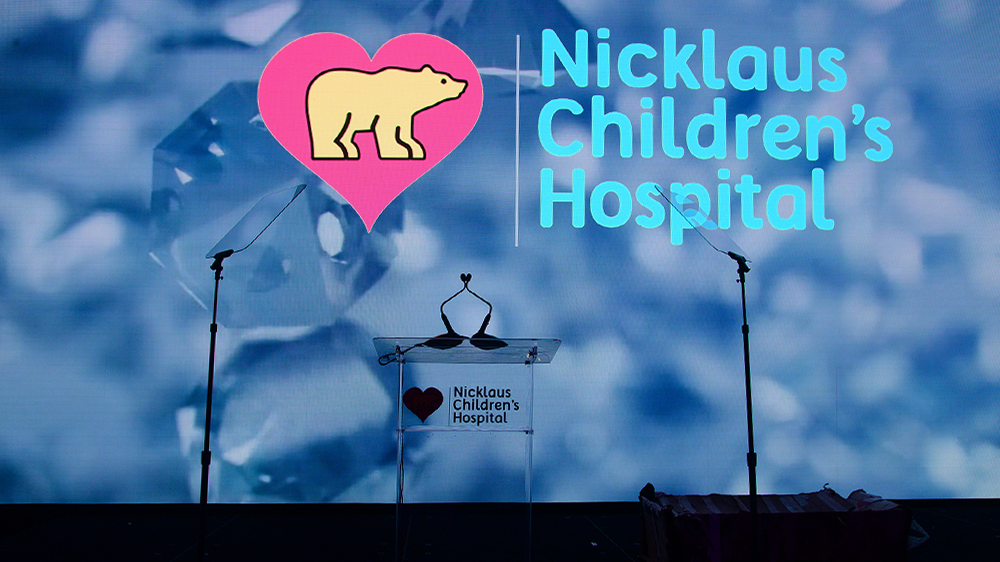 glass podium with Nicklaus Children's hospital logo.