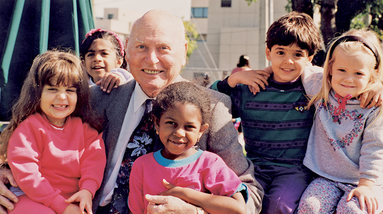 Ambassador David M. Walters surrounded by children