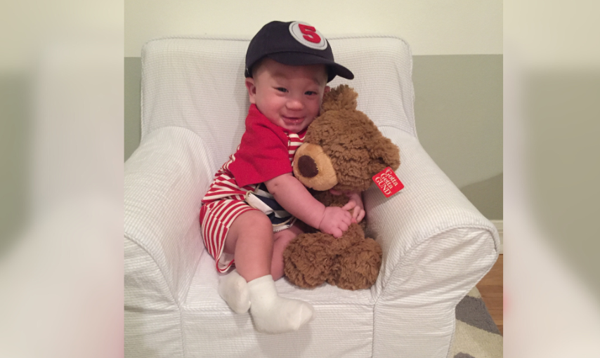 Jaxon hugging a stuffed teddy bear
