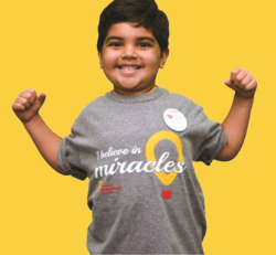 Leo smiling in his I believe in Miracles shirt