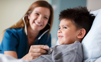 female nurse checking the heartbeat of a boy